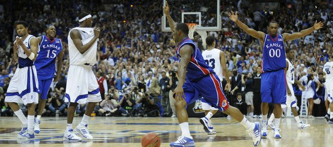 Kansas guard Sherron Collins, center, celebrates with Mario Chalmers (15) and Darrell Arthur (00) after the Jayhawks defeated Memphis in the national championship game on April 7, 2008, in San Antonio. KU and Memphis meet tonight for the first time since the title game.