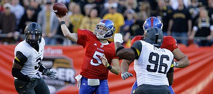 Kansas quarterback Todd Reesing heaves a pass over the Missouri defense during the first quarter, Saturday, Nov. 28, 2009 at Arrowhead Stadium.