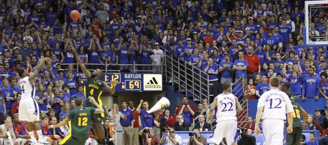 The Allen Fieldhouse crowd watches Kansas guard Sherron Collins put up a three-pointer over Baylor forward Quincy Acy with 1:12 left in the game to boost the Jayhawks over the Bears Wednesday, Jan. 20, 2010 at Allen Fieldhouse.