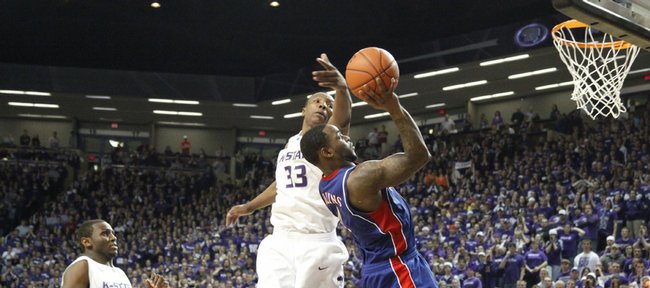 Kansas guard Sherron Collins gets a bucket over Kansas State forward Wally Judge after being fouled with seconds remaining in overtime Saturday, Jan. 30, 2010 at Bramlage Coliseum.