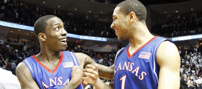 Kansas teammates Tyshawn Taylor (10) and Xavier Henry bump fists as they walk off the court smiling after the Jayhawks' 59-54 win over Texas A&M, Monday, Feb. 15, 2010 at Reed Arena in College Station, Texas.