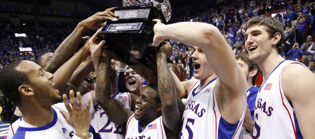 The Kansas Jayhawks dance with their sixth-consecutive Big 12 Conference title trophy after their 81-68 win over Oklahoma, Monday, Feb. 22, 2010 at Allen Fieldhouse. From left are Travis Releford, Sherron Collins, Cole Aldrich and Jeff Withey.