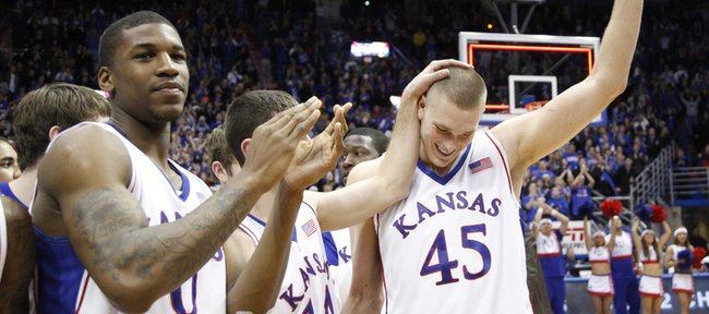 Kansas center Cole Aldrich waves to the Allen Fieldhouse crowd after he was announced the NCAA Basketball Academic All-American of the Year Monday, Feb. 22, 2010.