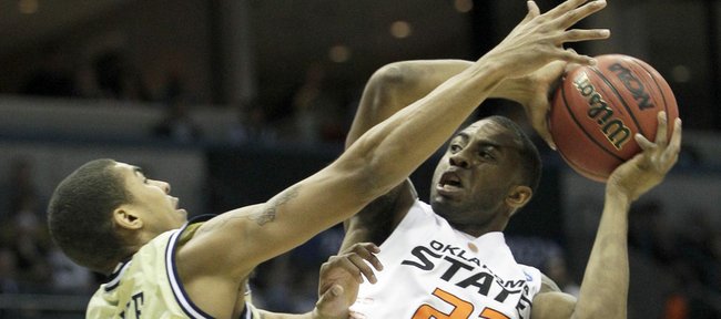 Oklahoma State's James Anderson (23) is defended by Georgia Tech's Glen Rice, Jr. (14), in the first half of an NCAA first-round college basketball game in Milwaukee, Friday, March 19, 2010.