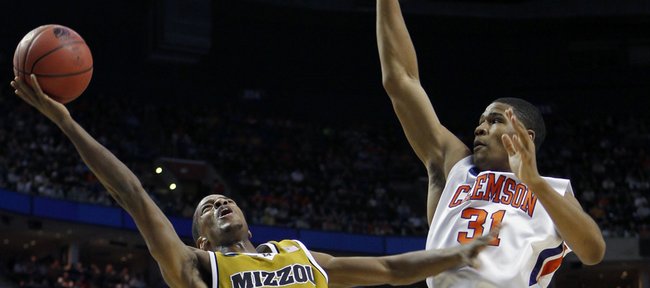 Missouri's Kim English (24) takes a shot as Clemson's Devin Booker (31) defends during the first half of an NCAA first-round college basketball game in Buffalo, N.Y., on Friday, March 19, 2010.