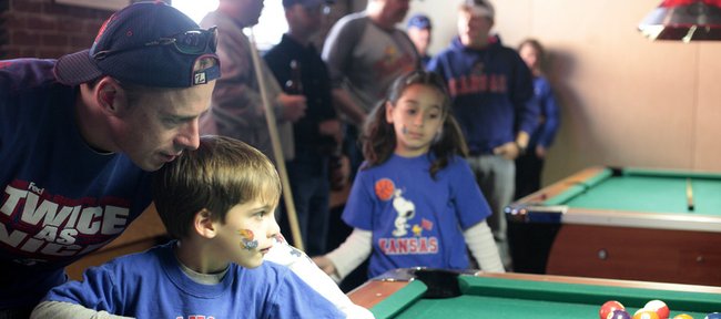 Mike Dalke, Dallas, helps his son Ben, 5, line up a pool shot at the Bricktown Brewery during a Kansas Alumni gathering before KU's game Thursday March 18, 2010. Dalke is a 1991 KU graduate. His daugher Madeline, 8, is in the background at center.