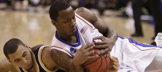 Kansas guard Tyshawn Taylor wrestles for a loose ball with Lehigh guard Marquis Hall during the first half, Thursday, March 18, 2010 at the Ford Center in Oklahoma City.