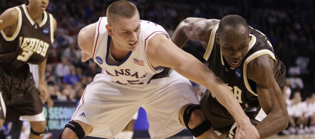 Kansas center Cole Aldrich and Lehigh forward Zahir Carrington compete for a loose ball during the first half, Thursday, March 18, 2010 at the Ford Center in Oklahoma City.