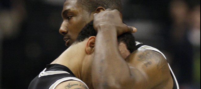 Wofford's Terry Martin, right, consoles Cameron Rundles after losing to Wisconsin during an NCAA first-round college basketball game in Jacksonville, Fla., Friday, March 19, 2010. Wisconsin defeated Wofford 53-49. 