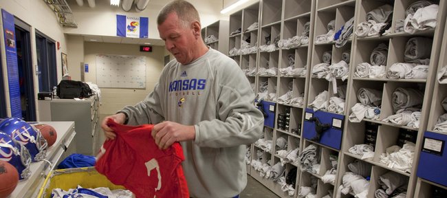 Jeff Himes, head football equipment manager, finds the practice jersey belonging to quarterback Kale Pick on Wednesday in preparation for the start of spring drills. The preseason workouts begin Saturday.