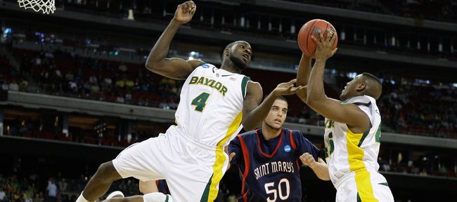 Baylor's Quincy Acy, left, and Tweety Carter, right, go for a rebound against Saint Mary's Omar Samhan during the first half of an NCAA South Regional semifinal college basketball game in Houston, Friday, March 26, 2010.