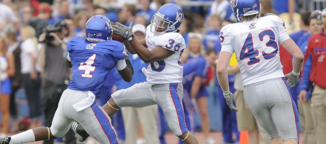 Kansas running back Deshaun Sands (36) grabs a pass in front of Blue Team safety Prinz Kande (4) during the first half of the April 24 Spring Game at Memorial Stadium. Sands, son of former KU great Tony Sands, is in the mix at running back this fall, his red-shirt freshman season.