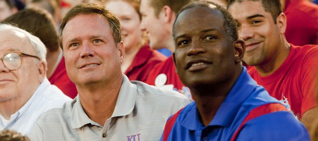 Kansas men’s basketball coach Bill Self, left, and football coach Turner Gill were on hand for Traditions Night on Monday at Memorial Stadium.