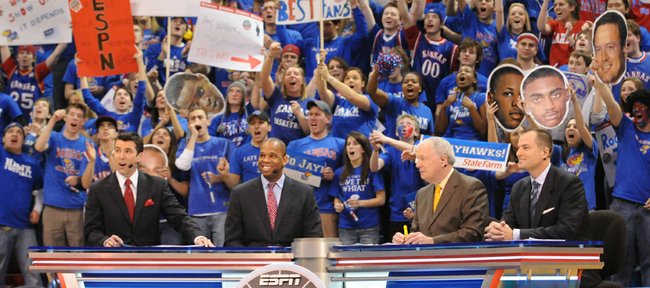 Kansas fans go wild as members of the ESPN College GameDay crew Rece Davis, left, Hubert Davis, Digger Phelps and Jay Bilas go live from James Naismith Court at Allen Fieldhouse. Students were allowed to enter around 8 a.m.