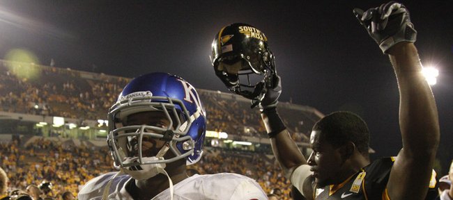 Kansas running back James Sims walks off the field as Southern Miss defensive back Chico Hunter raises his arms in victory following the Jayhawks 31-16 loss to the Golden Eagles, Friday, Sept. 17, 2010 at M.M. Roberts Stadium in Hattiesburg, Mississippi.