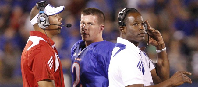 Kansas coach Turner Gill, right, quarterback Jordan Webb, center, and Joe Dailey, KU’s on-campus recruiting coordinator, come together on the sideline during Kansas’ Sept. 4 game against North Dakota State. Dailey had been signalling in plays on the sideline for KU’s first two games, a violation of NCAA rules the Jayhawks rectified in their third game.