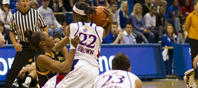 Kansas University guard Marisha Brown (22) and Fort Hays State University guard Kaniesha Pettaway fight for a possession. The Jayhawks claimed an 83-62 exhibition victory Sunday in Allen Fieldhouse.