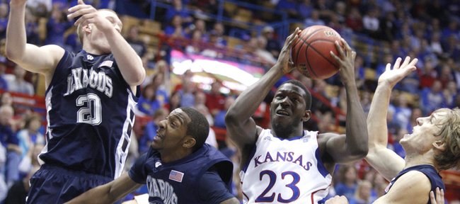 Kansas forward Mario Little pulls a rebound away from Washburn defenders Bobby Chipman (20), Nate Daniels (33) and Logan Stutz, right, in the second half of the exhibition game, Tuesday, Nov. 2, 2010 at Allen Fieldhouse.