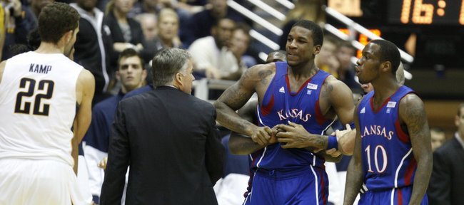 Kansas forward Thomas Robinson tries to break free from being restrained after tempers flared against Cal during the second half as Tyshawn Taylor (10) and Cal’s Harper Camp (22) hang out on the periphery.