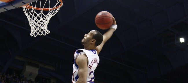 Kansas guard Travis Releford soars in for a windmill dunk in front of UMKC defenders Trinity hall, left, and Bakari Lewis during the second half on Wednesday, Jan. 5, 2011 at Allen Fieldhouse.