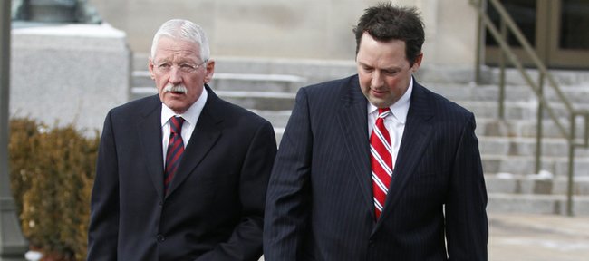 Former University of Kansas official Rodney Jones, right, leaves the U.S. Federal Courthouse in Wichita, Kan., on Friday, Jan. 14, 2011, with his attorney, Gerald Handley, after appearing in court, accused of conspiring to steal more than $2 million in tickets to athletic events. 