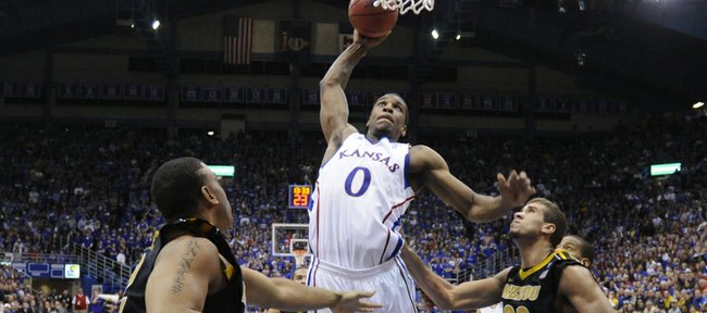 Kansas forward Thomas Robinson delivers a tomahawk jam between Missouri defenders Steve Moore, left, and Justin Safford during the second half on Monday, Feb. 7, 2011 at Allen Fieldhouse.