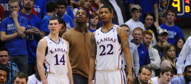 Tyrel Reed, (14) an injured Thomas Robinson, center and Marcus Morris (22) watch the final minutes of the Jayhawk's 89-66 win over Iowa State Saturday, Feb. 12, 2011 at Allen Fieldhouse.