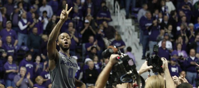 Kansas State guard Jacob Pullen celebrates with the Bramlage Coliseum crowd following the Wildcats' 84-68 upset win over Kansas on Monday, Feb. 14, 2011.