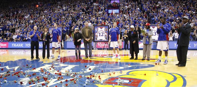 The Kansas University seniors and their families — from left, Tyrel Reed, Brady Morningstar and Mario Little — are showered with applause and flowers prior to tipoff of the Jayhawks’ game against Texas A&M. KU won on Senior Night, 64-51, Wednesday, March 2, 2011 at Allen Fieldhouse.