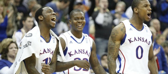 Kansas players Tyshawn Taylor, left, Josh Selby and Thomas Robinson celebrate a bucket and a foul created by teammate Mario Little against Oklahoma State with time dwindling in the second half on Thursday, March 10, 2011 at the Sprint Center in Kansas City.