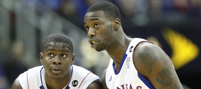 Kansas guard Josh Selby (32) and Elijah Johnson (15) talk during a couple of free throws during the first half on Thursday, March 10, 2011 at the Sprint Center in Kansas City.