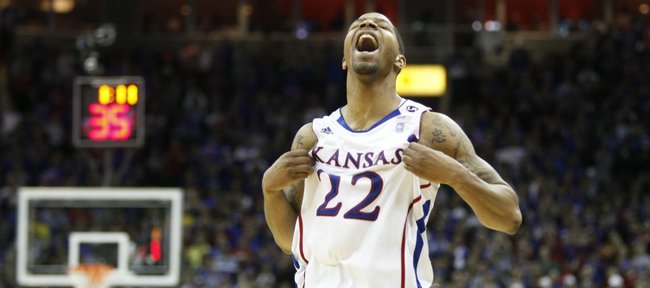 Kansas forward Marcus Morris puffs his jersey with little time remaining against Texas during Big 12 championship.