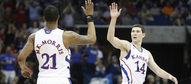 Kansas guard Tyrel Reed high fives forward Markieff Morris after a three by Morris against Illinois during the first half on Sunday, March 20, 2011, at the BOK Center in Tulsa.