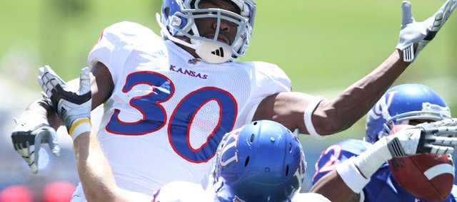 Cornerback Anthony Davis watches as receiver Christian Matthews comes away with a pass for a touchdown during the Kansas Spring Game on Saturday, April 30, 2011 at Kivisto Field.