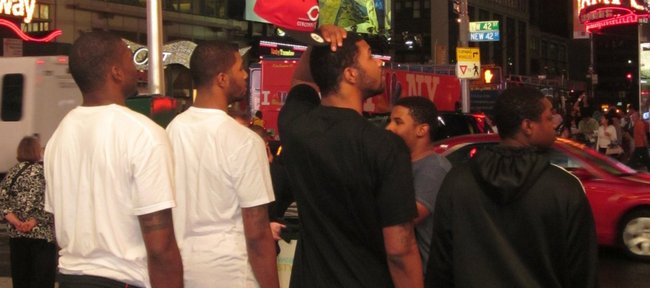 Kansas University forwards Marcus Morris (black shirt and red hat) and Markieff Morris (second from left) take a minute to soak up the scene at Times Square in New York on Wednesday, the eve of the 2011 NBA Draft. Joining the Morris twins are, from left, Sean Evans, Julius Kane and Guy Lipscomb. 