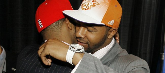 Twin brothers Markieff, right, and Marcus Morris, who played together at Kansas, embrace each other after they were picked No. 13 and No. 14, respectively, during the NBA basketball draft, Thursday, June 23, 2011 in Newark, N.J. Markieff was picked by the Phoenix Suns while Marcus was picked by the Houston Rockets.