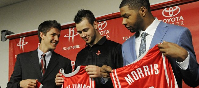 Houston Rockets draft picks Marcus Morris, right, Donatas Motiejunas, center, and Chandler Parsons receive their jerseys during an introductory news conference on Friday in Houston.