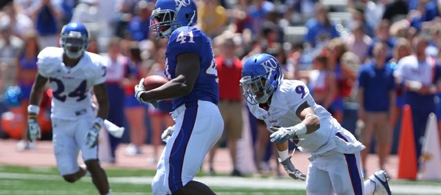 Nick Krug/Journal-World Photo.Kansas tight end Jimmay Mundine looks to run after a reception during the Kansas Spring Game on Saturday, April 30, 2011 at Kivisto Field. On defense are safety Keeston Terry (9) and safety Bradley McDougald (24).
