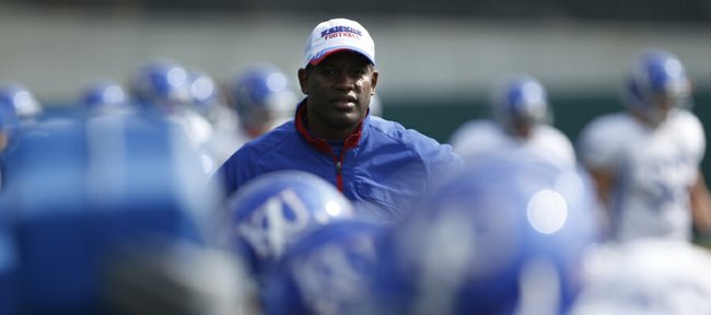 Kansas head coach Turner Gill watches as the defense works out on the sleds during football practice on Monday, April 18, 2011 at the practice fields near Memorial Stadium.