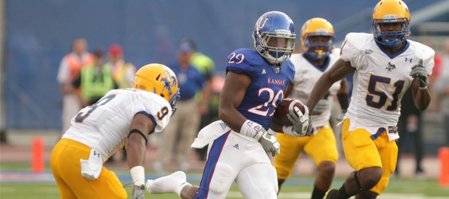 Kansas running back James Sims cuts through a hole as he heads up the field for a big gain against McNeese State during the first quarter on Saturday, Sept. 3, 2011 at Kivisto Field.