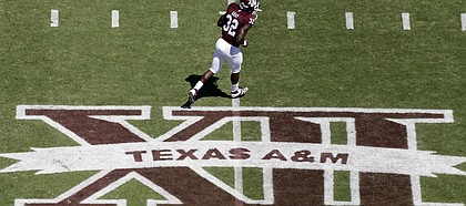 In this photo taken Saturday, Sept. 24, 2011, Texas A&M running back Cyrus Gray (32) runs across the field before taking on Oklahoma State in College Station, Texas.