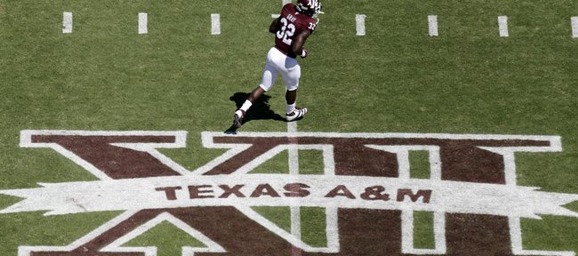 In this photo taken Saturday, Sept. 24, 2011, Texas A&M running back Cyrus Gray (32) runs across the field before taking on Oklahoma State in College Station, Texas.