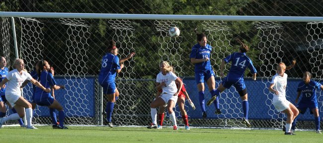 The Kansas defense works to prevent a shot on goal from Texas during a corner kick in the first half on Friday, Sept. 30, 2011.