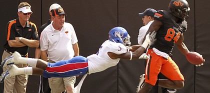 Kansas cornerback Greg Brown lays out to force Oklahoma State receiver Hubert Anyiam out of bounds after a long reception during the first quarter on Saturday, Oct. 8, 2011 at Boone Pickens Stadium.