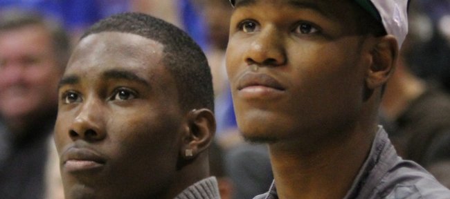 Kansas freshmen Jamari Traylor, left, and Ben McLemore  watch the Late Night in the Phog festivities from the bench on Friday, Oct. 14, 2011 at Allen Fieldhouse.