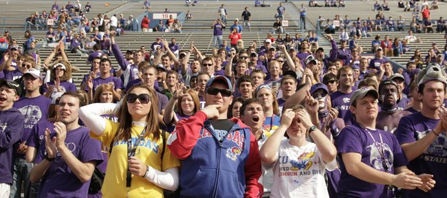 A handful of remaining Kansas fans watch the final minutes of play from the Jayhawk student section as it is overrun with Kansas State fans on Saturday, Oct. 22, 2011 at Kivisto Field.