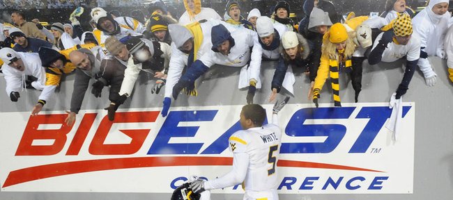In this Dec. 6, 2008, file photo, then-West Virginia quarterback Pat White waves farewell to the fans following his last game with the team, a 13-7 West Virginia win over South Florida in Morgantown, W.Va. West Virginia University has filed a lawsuit seeking immediate withdrawal from the Big East Conference so it can join the Big 12.
