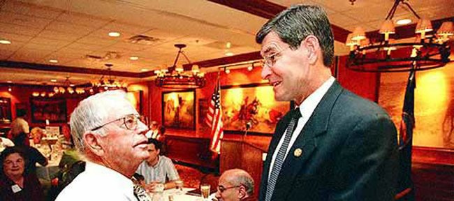 Former Kansas University track and cross country coach Bob Timmons, left, enjoys a few moments of conversation with Rep. Jim Ryun, R-Kan., during a Lawrence Chamber of Commerce Luncheon in this 2001 file photo. Timmons will be inducted into the USA Track and Field Hall of Fame.
