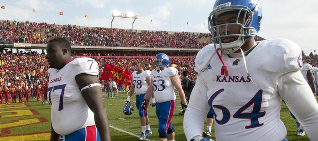 Kansas offensive lineman Jeremiah Hatch (77) and defensive tackle Randall Dent (64) leave the field with blank stares following the Jayhawks' 13-10 loss to Iowa State on Saturday, Nov. 5, 2011 at Jack Trice Stadium in Ames, Iowa.