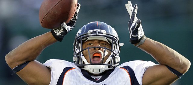 Former Kansas University football player and current Denver Broncos cornerback Chris Harris (25) celebrates after intercepting a throw from Oakland Raiders quarterback Carson Palmer in the third quarter of a game in Oakland, California.